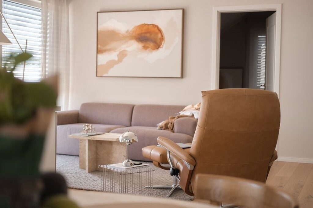 Ingelijst abstract kunstwerk in een lichte woonkamer met veel daglicht